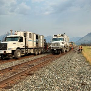 Two Holland flashbutt welding trucks working next to each other on rail.